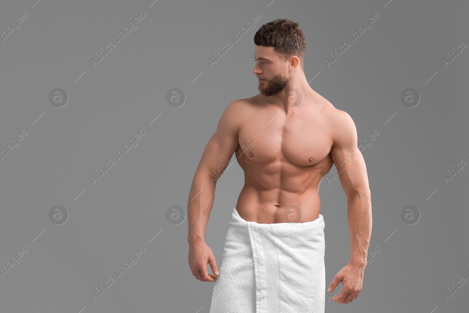 Photo of Handsome muscular man on grey background, space for text. Sexy body