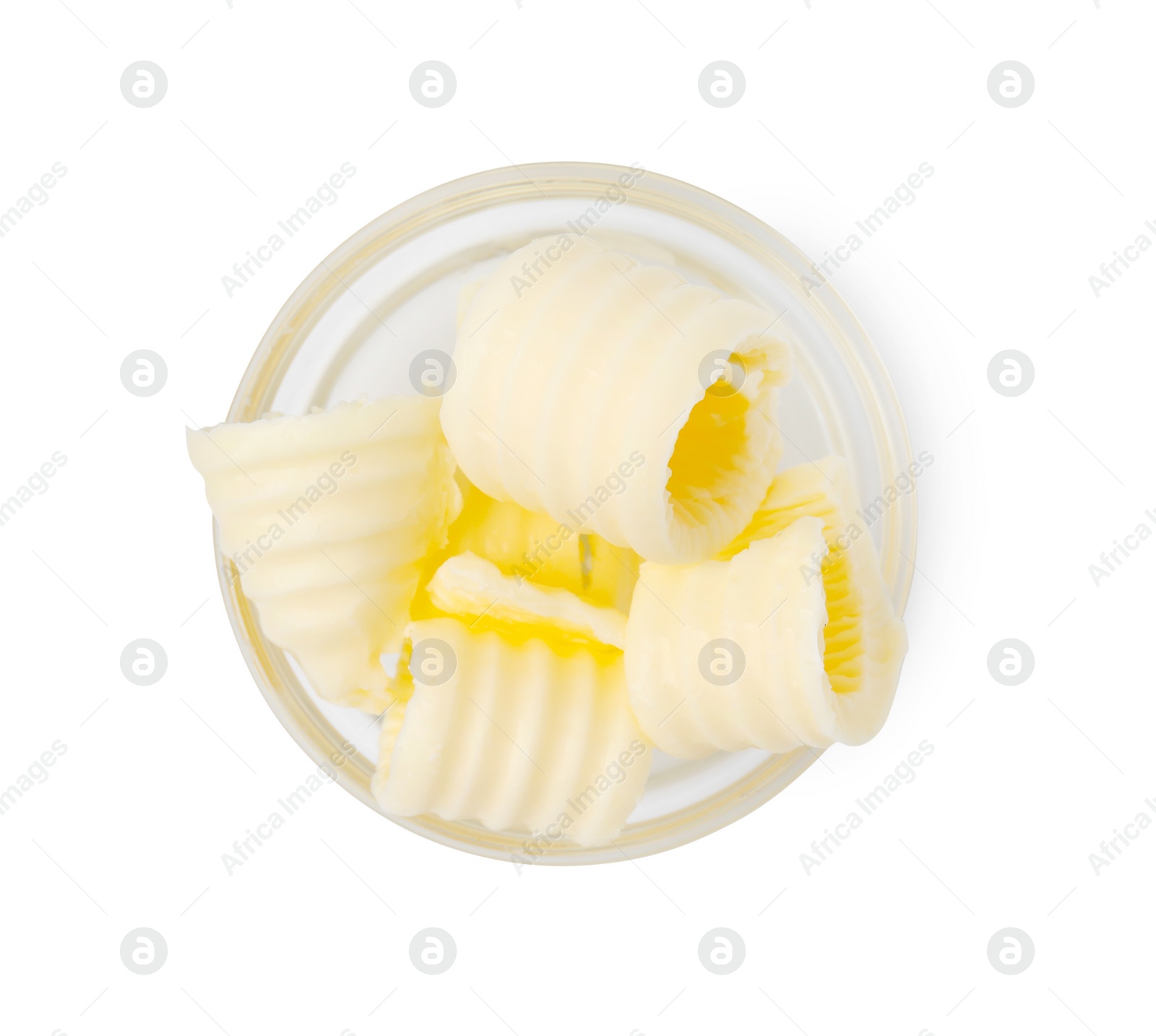 Photo of Tasty butter curls in bowl isolated on white, top view
