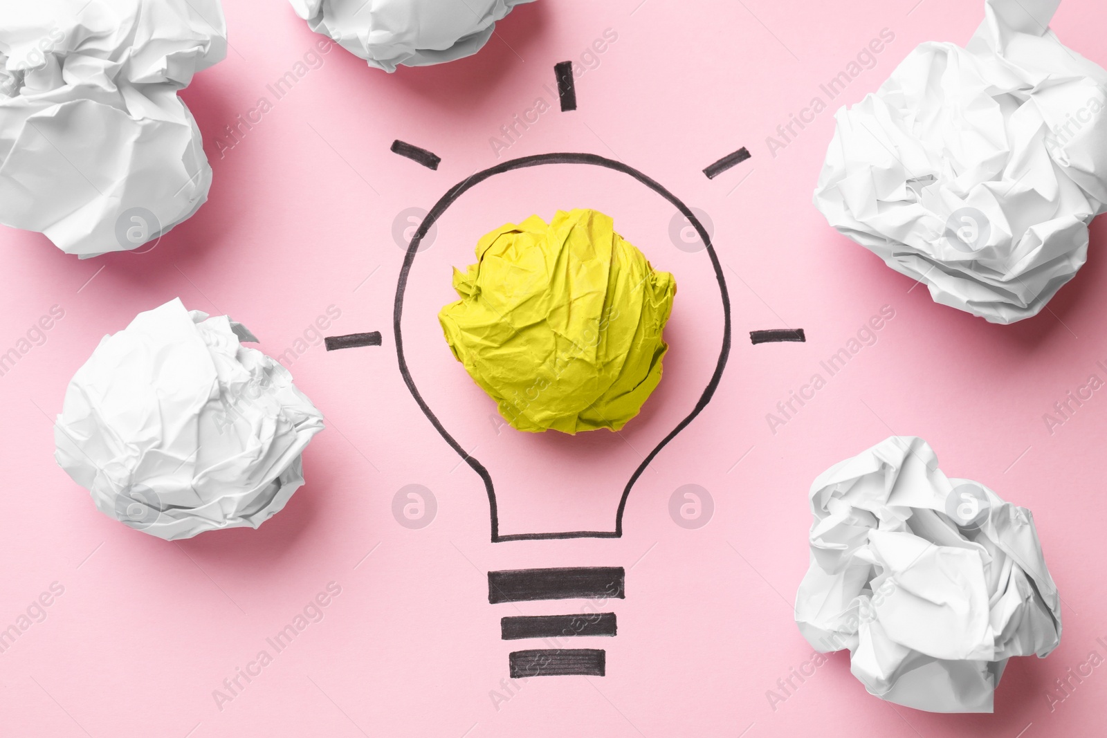 Photo of Idea concept. Light bulb made with crumpled paper and drawing on pink background, flat lay