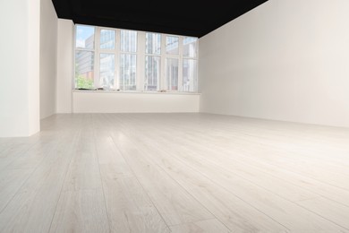 Empty room with new white laminated flooring