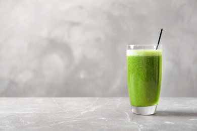 Photo of Glass with delicious detox juice on table