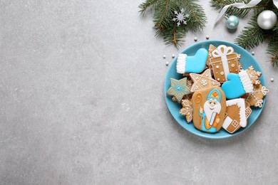Photo of Tasty gingerbread cookies and space for text on light grey table, flat lay. St. Nicholas Day celebration