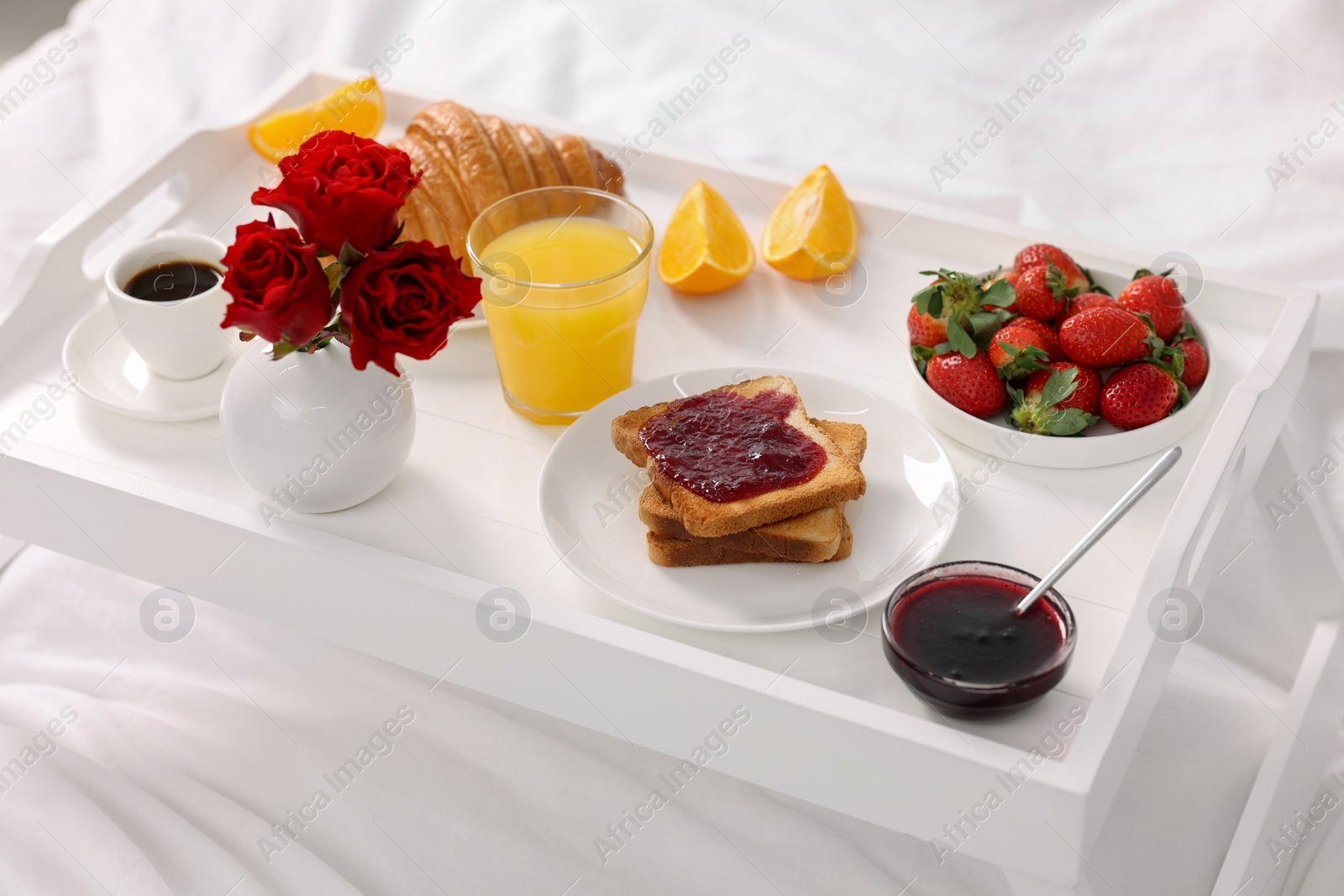 Tray with delicious breakfast on bed, closeup Photo of Tray with delicious breakfast on bed, closeup