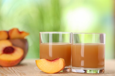 Photo of Tasty peach juice and fresh fruit on wooden table outdoors, closeup