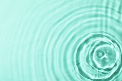 Photo of Closeup view of water with rippled surface on light blue background