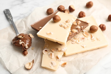 Delicious milk and white chocolate bars on table