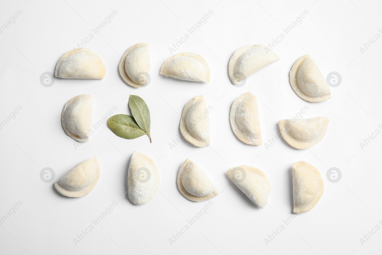 Photo of Raw dumplings on white background, top view. Home cooking