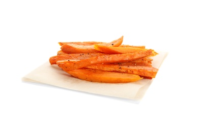 Parchment with tasty sweet potato fries on white background