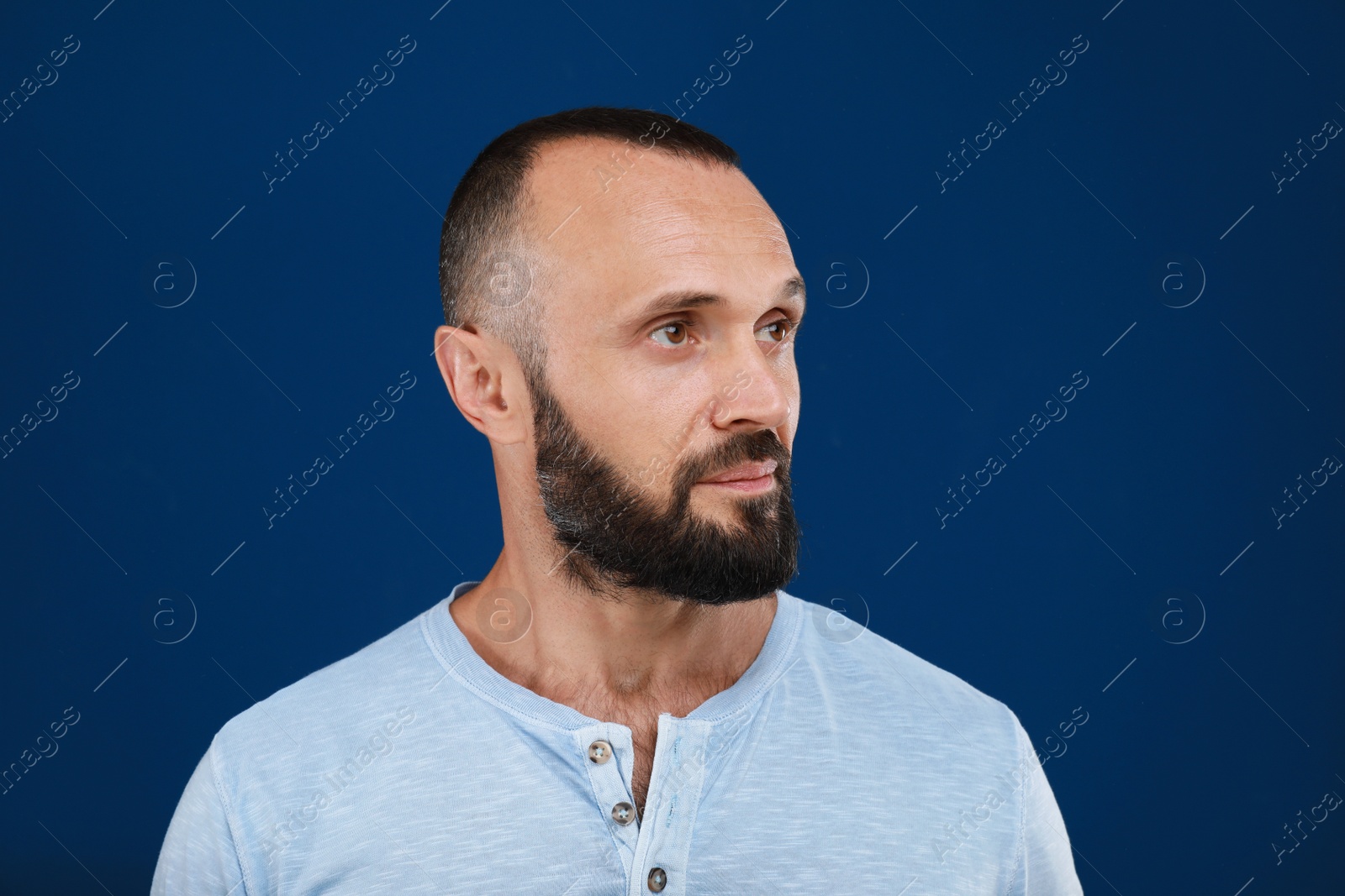 Photo of Portrait of handsome man on blue background