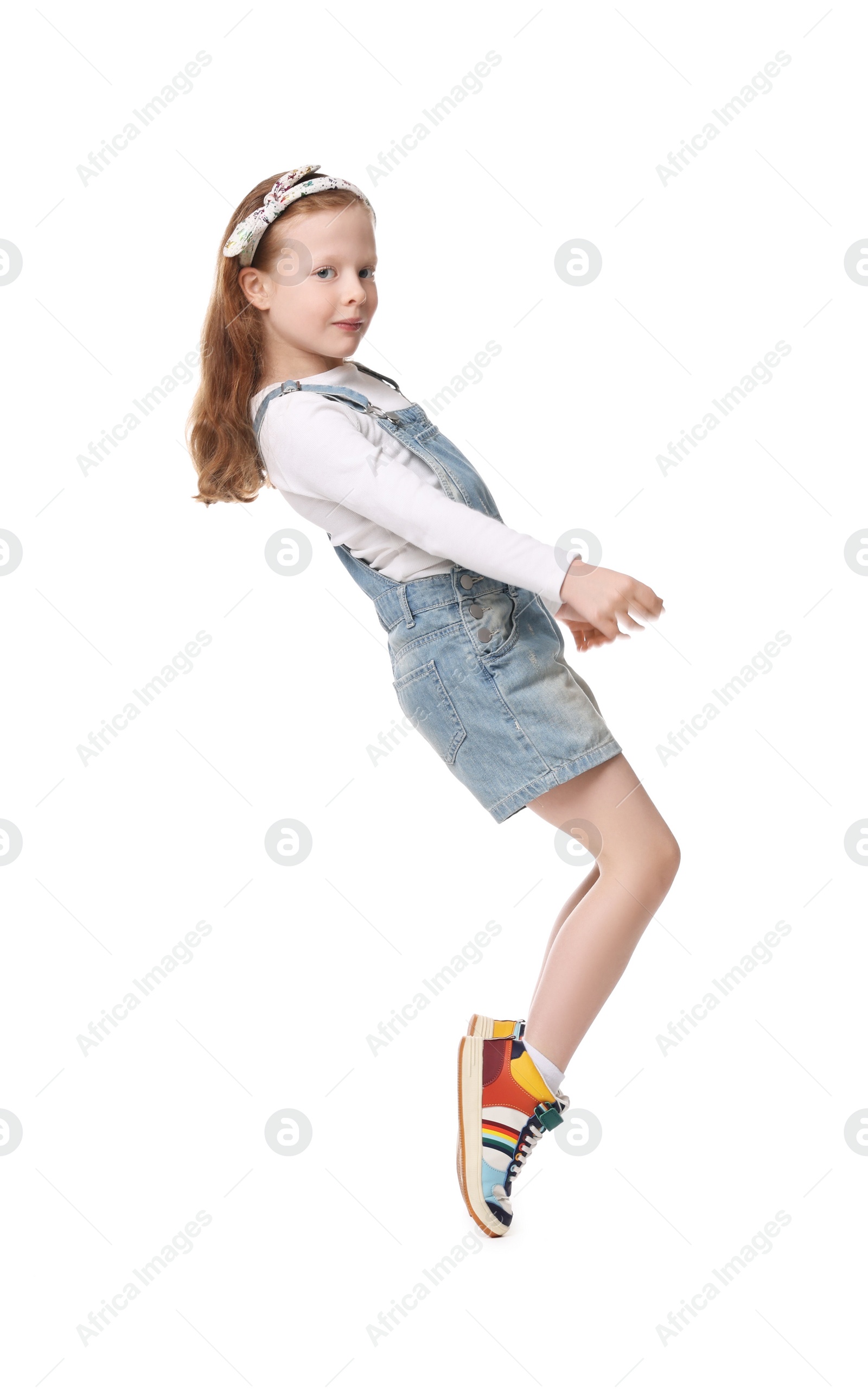 Photo of Cute little girl dancing on white background