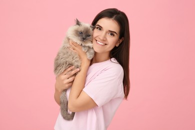 Photo of Woman with her cute cat on pink background