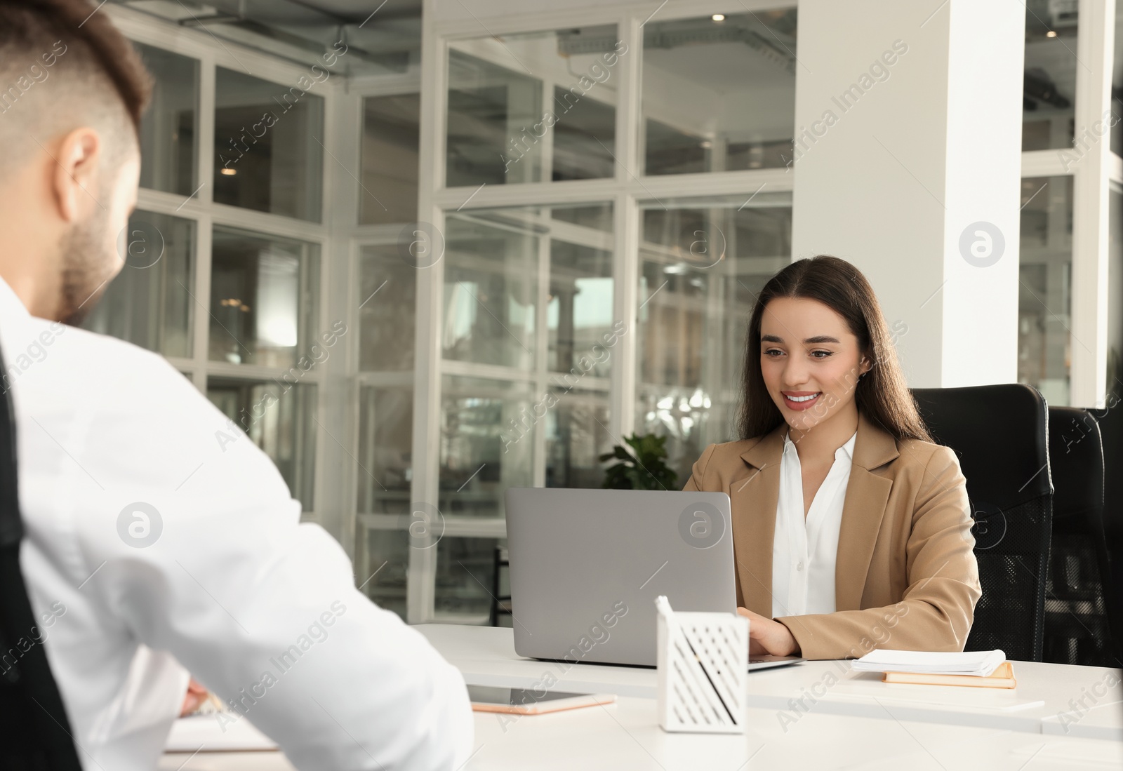 Photo of Colleagues working together in open plan office