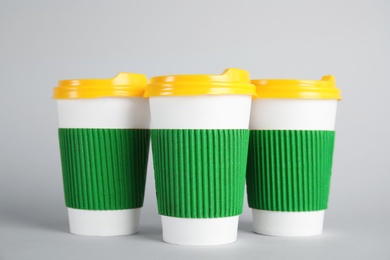 Photo of Carton cups on grey background. Mock up for design