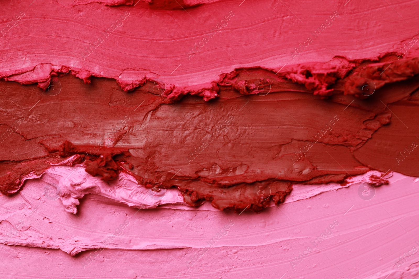 Photo of Texture of beautiful lipsticks as background, top view