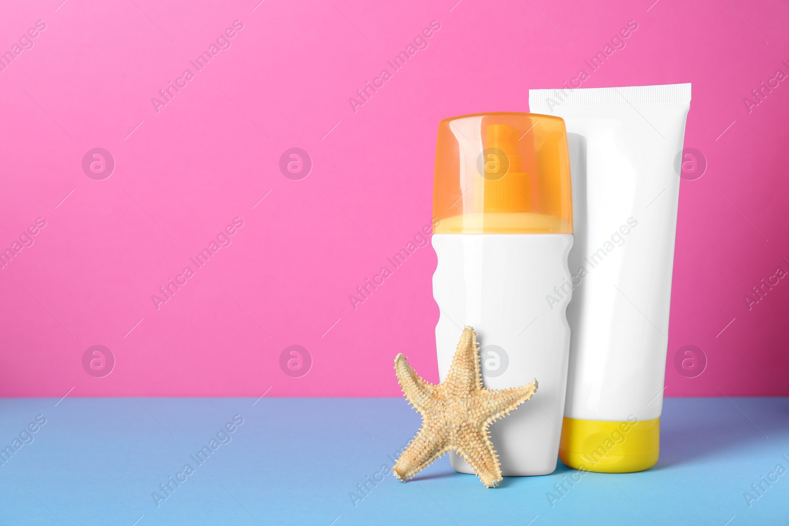 Photo of Suntan products and starfish on color background. Space for text