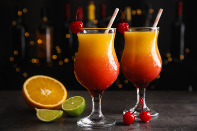 Photo of Fresh alcoholic Tequila Sunrise cocktails on grey table