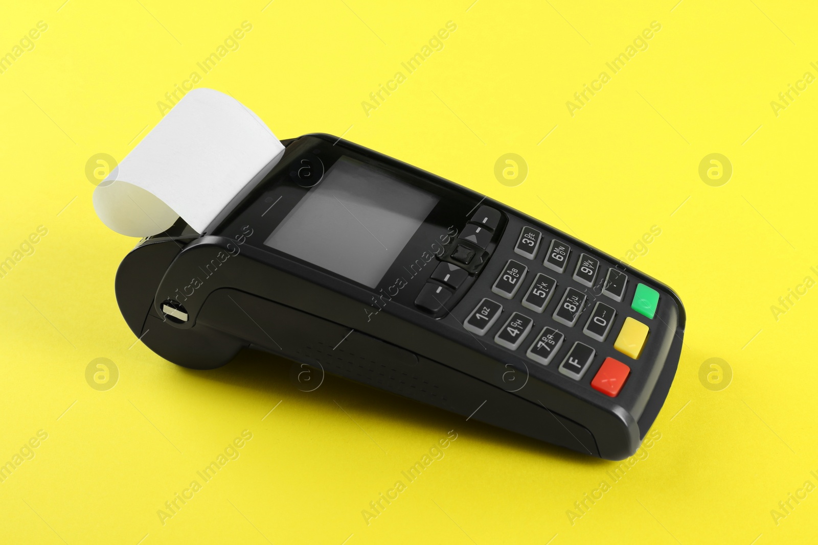 Photo of New modern payment terminal on yellow background