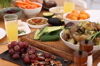 Photo of Healthy vegetarian food and glasses of juice on wooden table