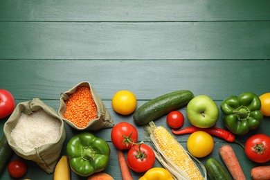 Photo of Fresh fruits, vegetables and seeds on green wooden table, flat lay. Space for text