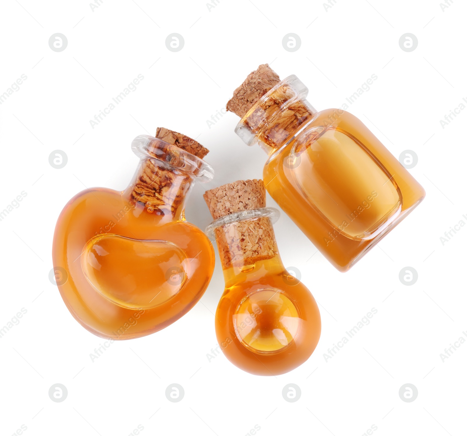Photo of Bottles of love potion isolated on white, top view