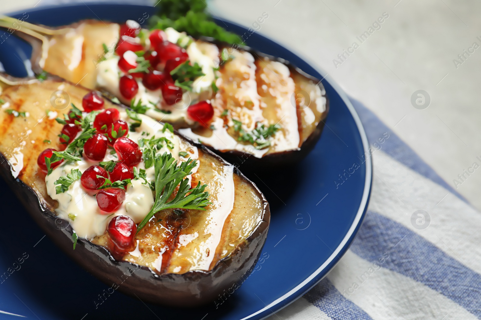 Photo of Plate with tasty fried eggplants on gray table