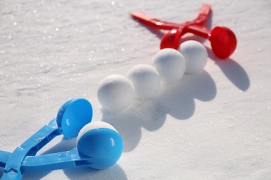 Photo of Snowballs and plastic tools outdoors on winter day