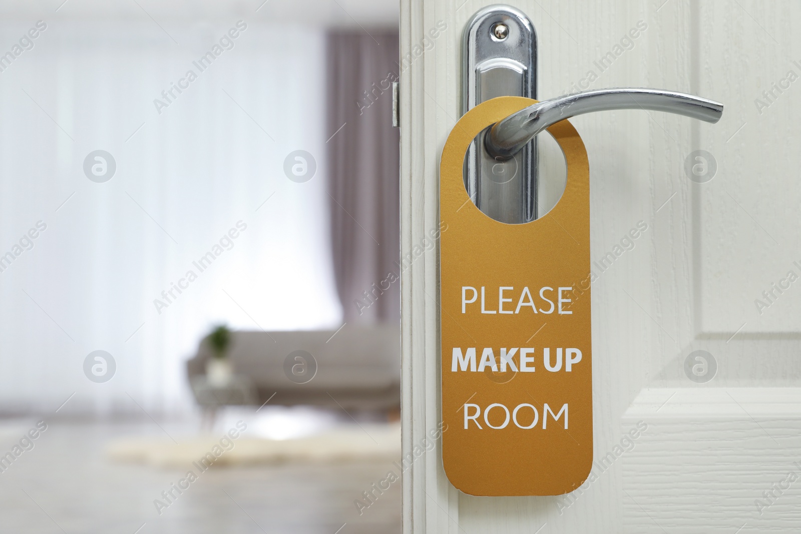 Photo of Open door with sign PLEASE MAKE UP ROOM on handle at hotel, space for text