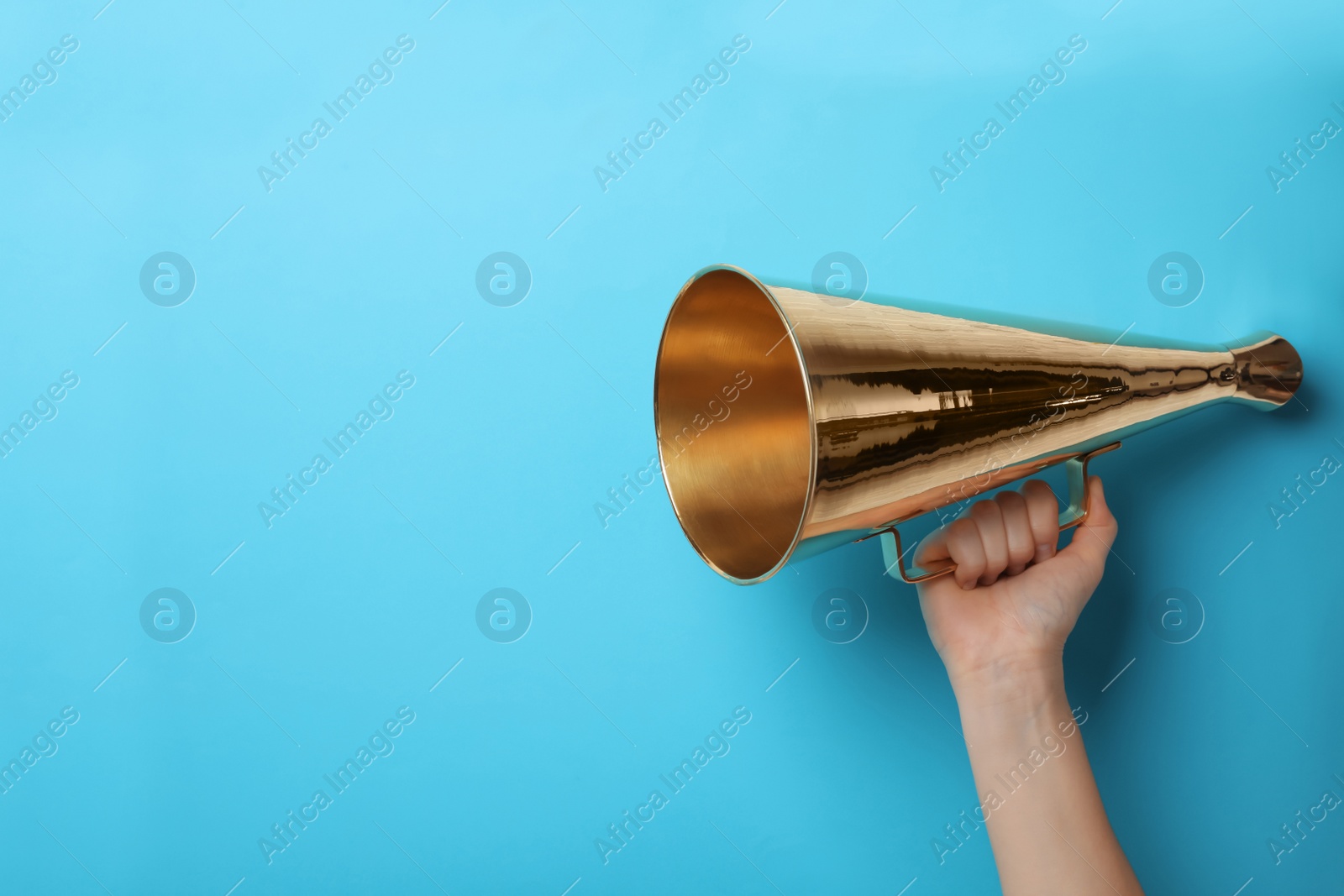 Photo of Woman holding retro megaphone on color background