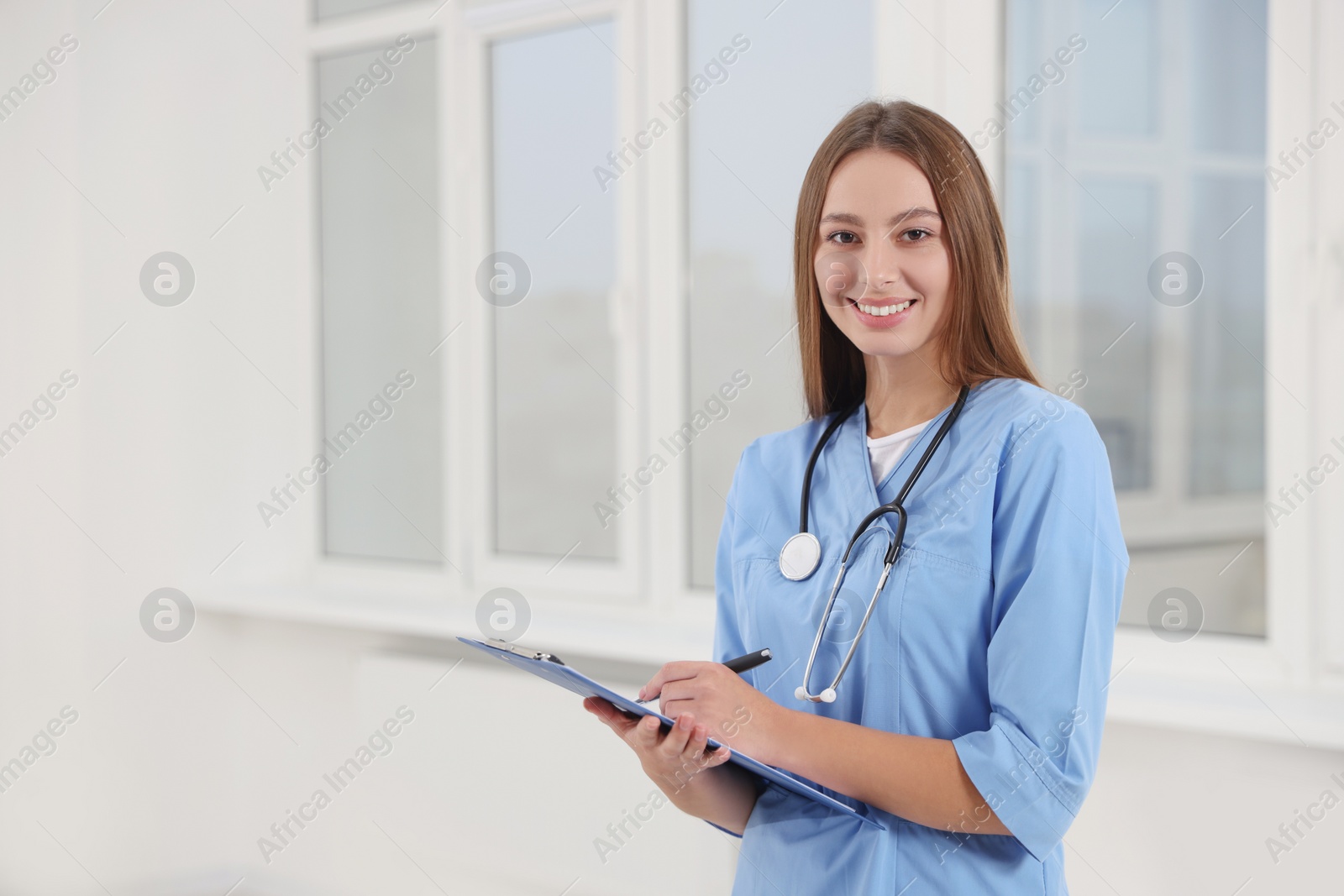 Photo of Portrait of young intern wearing uniform in university hall, space for text