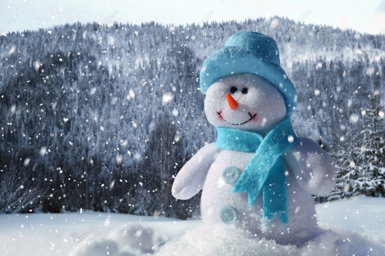 Image of Cute small decorative snowman outdoors on sunny day, space for text