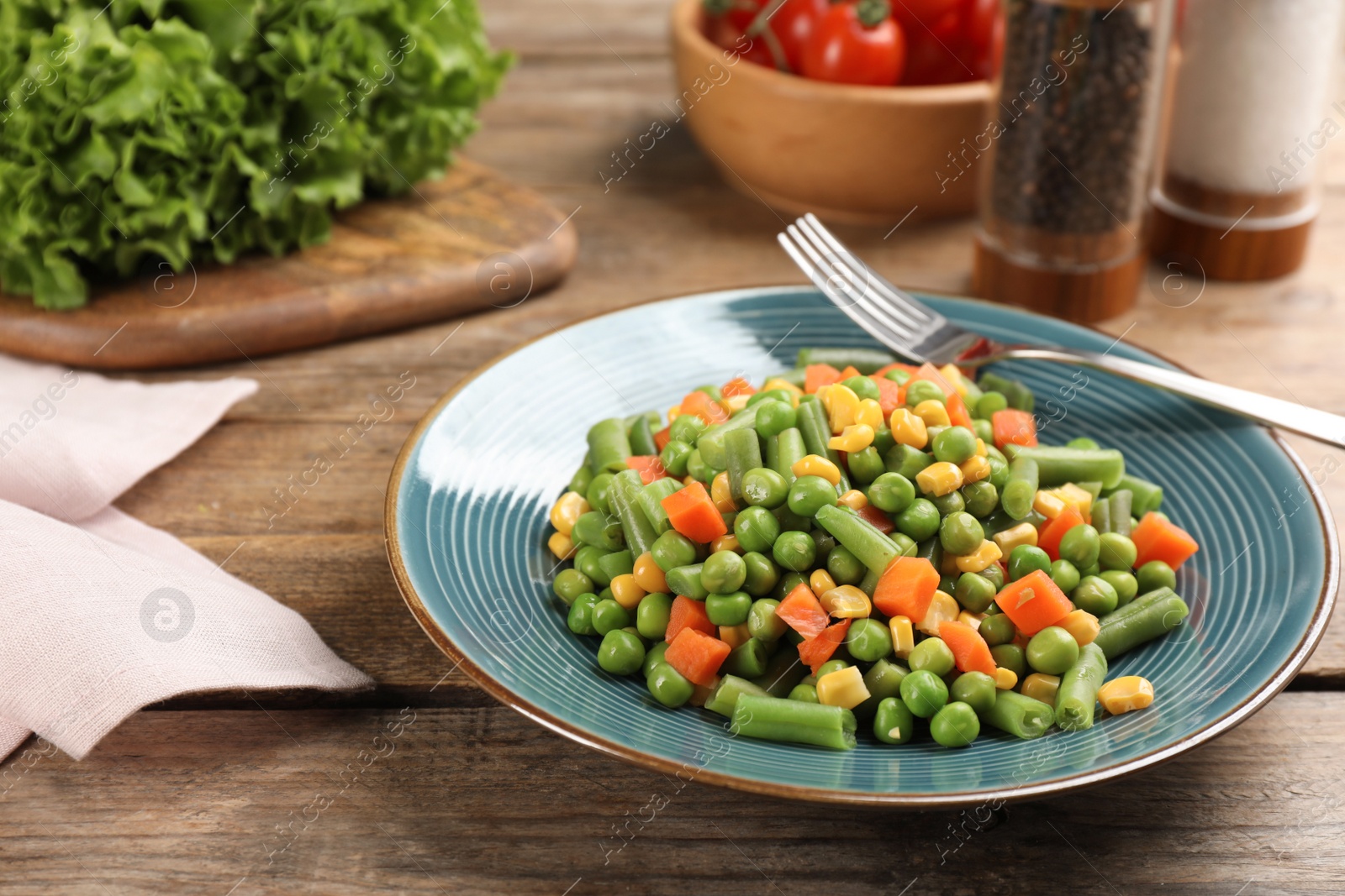 Photo of Mix of fresh vegetables served on  wooden table