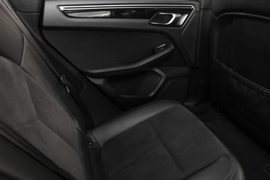 Photo of Leather seat inside of modern black car, closeup