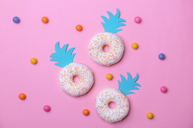 Fresh tasty donuts and candies on color background