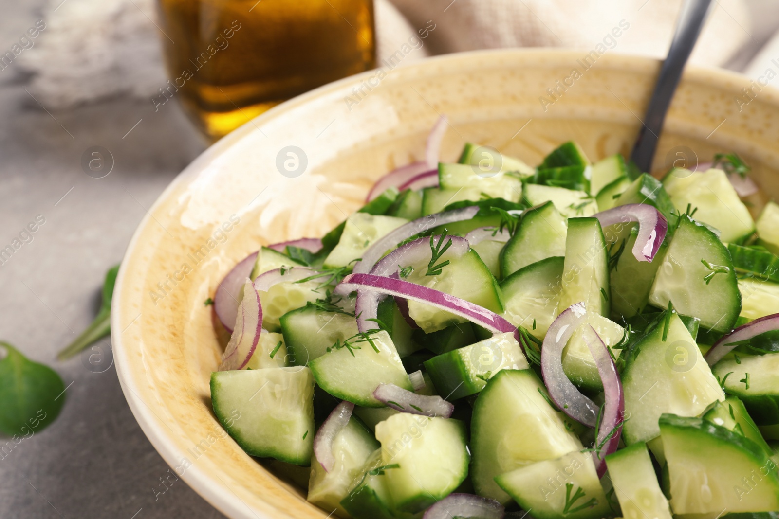 Photo of Plate with tasty cucumber salad on table, closeup