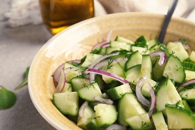 Photo of Plate with tasty cucumber salad on table, closeup