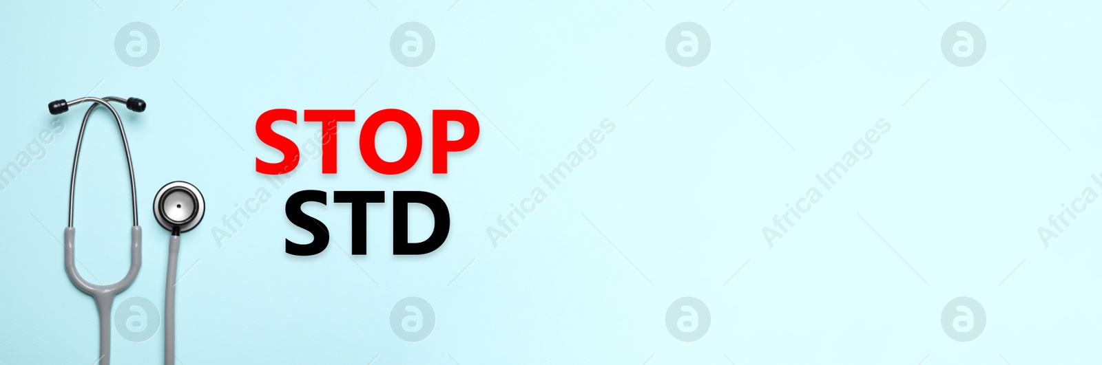 Image of Text STOP STD and stethoscope on light blue background, top view with space for text. Banner design