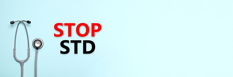 Image of Text STOP STD and stethoscope on light blue background, top view with space for text. Banner design