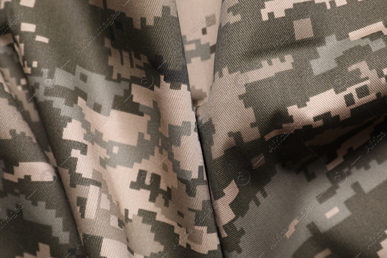 Photo of Texture of crumpled camouflage fabric as background, top view