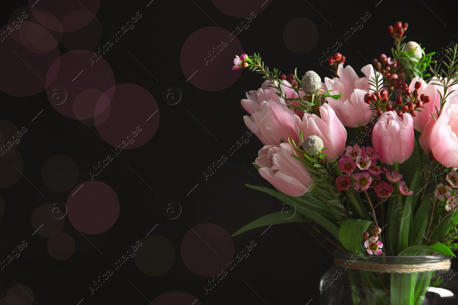 Photo of Beautiful bouquet with spring pink tulips on black background. Space for text
