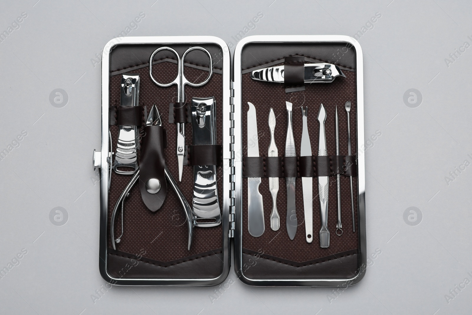 Photo of Manicure set in case on grey background, top view
