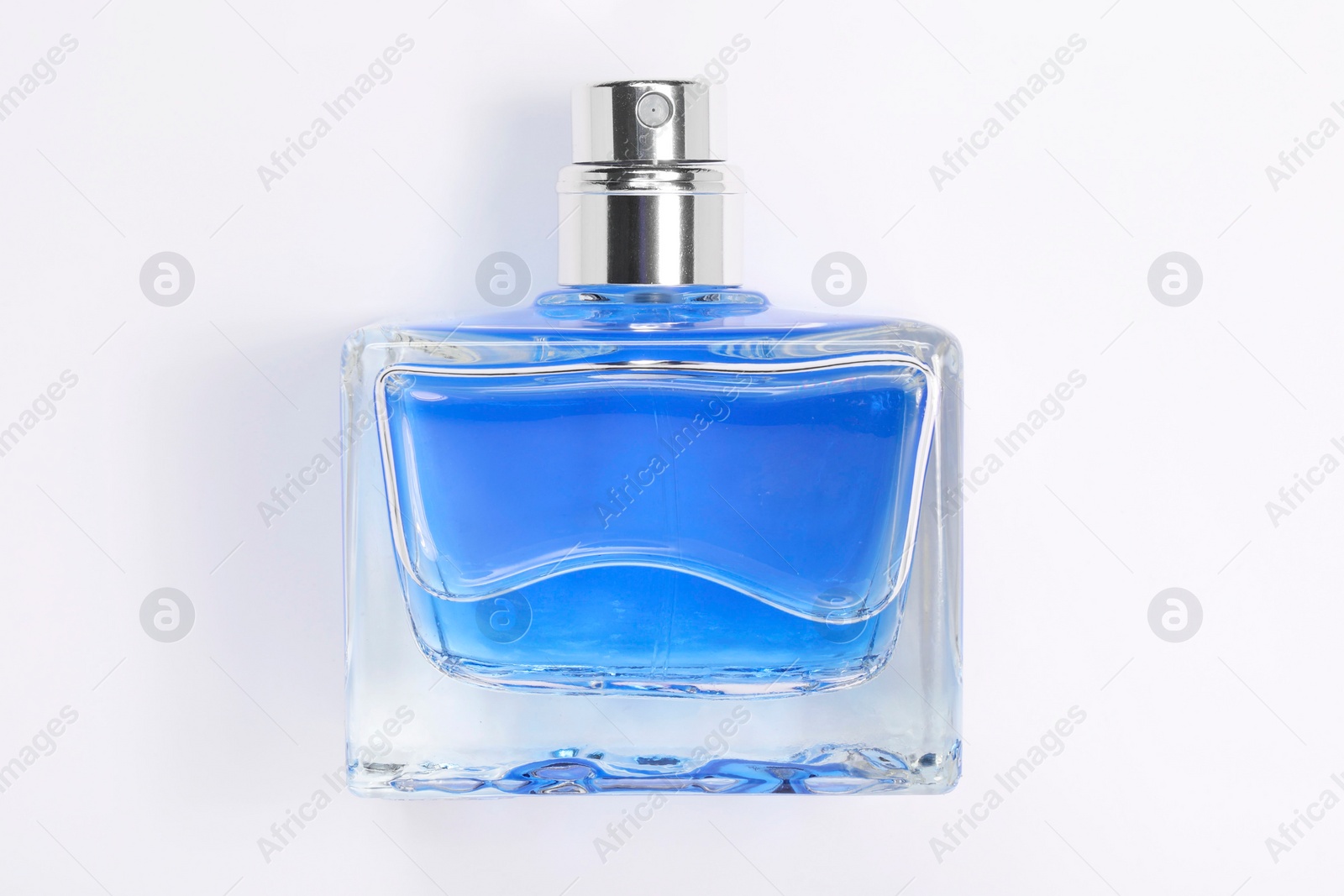 Photo of Blue men's perfume in bottle on white background, top view