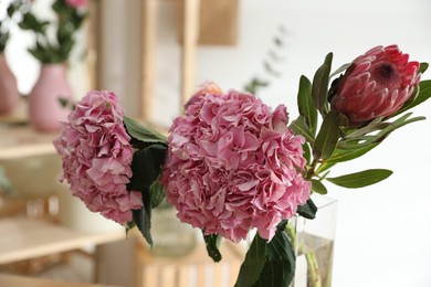 Photo of Fresh beautiful flowers in florist's workshop, closeup