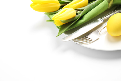 Festive Easter table setting with floral decor on white background, closeup