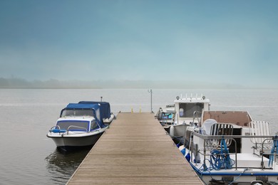 Picturesque view of wooden pier with moored boats