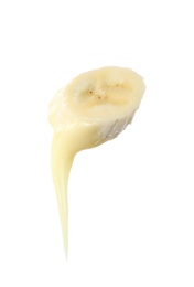 Photo of Fondue fork with slice of banana dipped into chocolate on white background