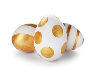 Set of traditional Easter eggs decorated with golden paint on white background