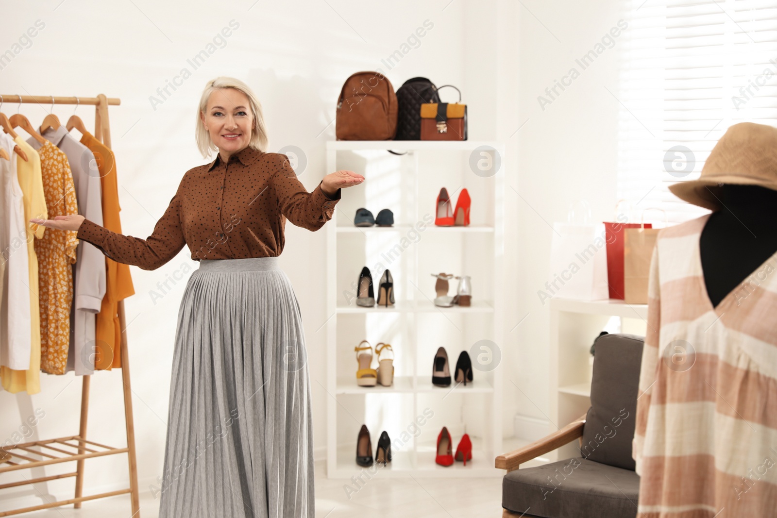 Photo of Female business owner in boutique. Space for text