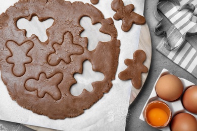 Flat lay composition with homemade gingerbread man cookies on grey table