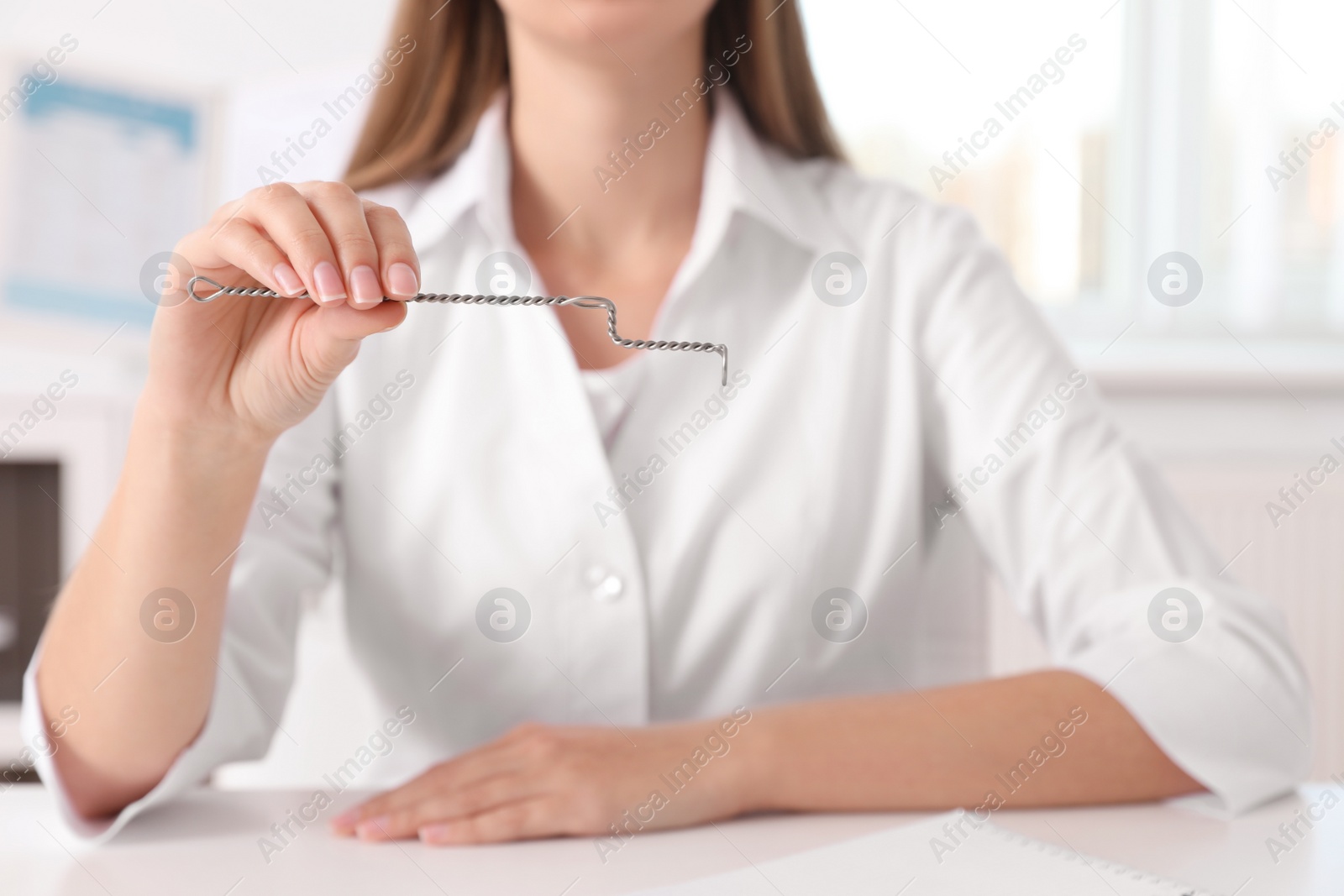 Photo of Speech therapist with logopedic probe in clinic, closeup