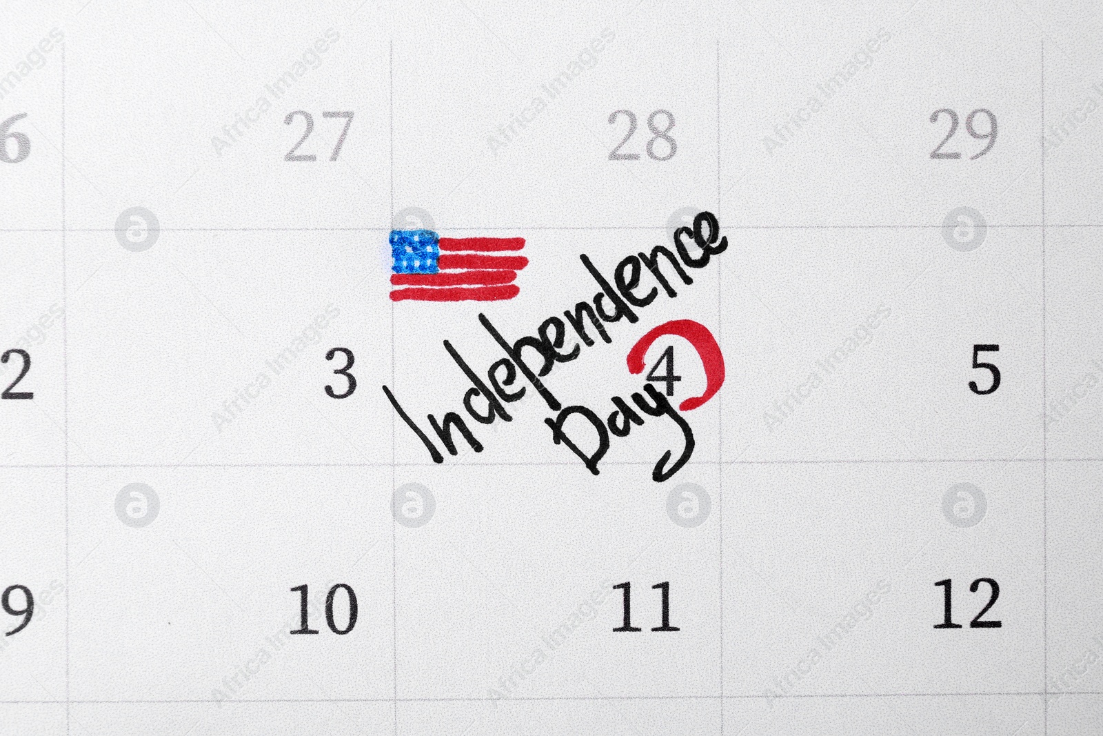 Photo of Calendar with inscription "Independence Day" and USA flag drawing, top view